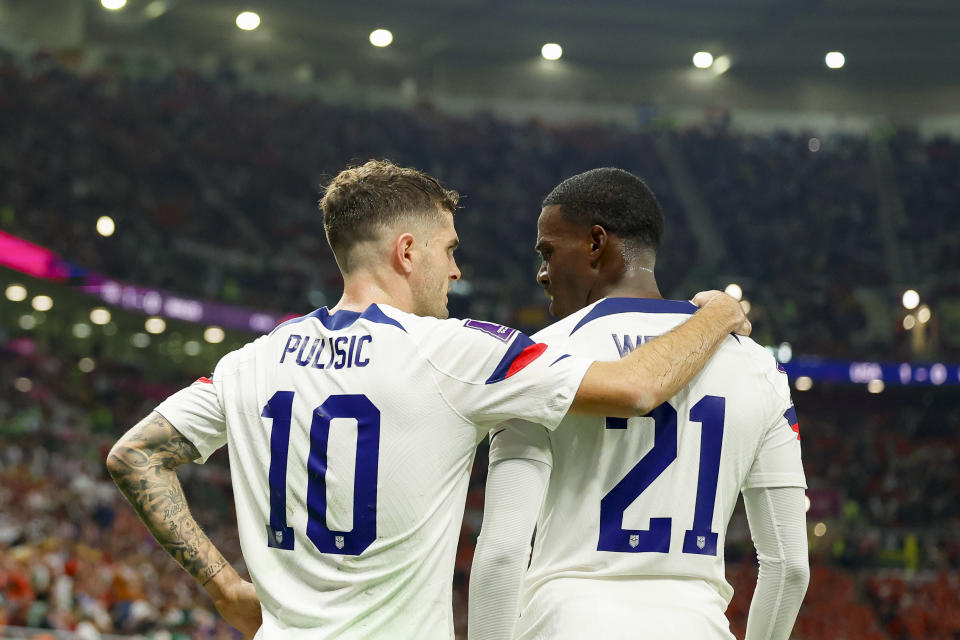 DOHA, QATAR - NOVEMBER 21: Christian Pulisic of USA and Timothy Weah of USA speaks with during the FIFA World Cup Qatar 2022 Group B match between USA and Wales at Ahmad Bin Ali Stadium on November 21, 2022 in Doha, Qatar. (Photo by Berengui/DeFodi Images via Getty Images)