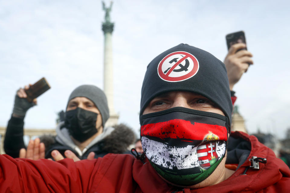 Hospitality sector workers take part in a protest, in Budapest, Hungary, Sunday, Jan. 31, 2021. Protesters gathered at a central square in Hungary's capital of Budapest on Sunday demanding a rethinking of the country's lockdown restrictions. As the lockdown limiting restaurants to take-away service approaches the three-month mark, many business owners complain that they have received little to none of the government’s promised financial assistance while other businesses like shopping malls and retail stores have been permitted to remain open. (AP Photo/Laszlo Balogh)