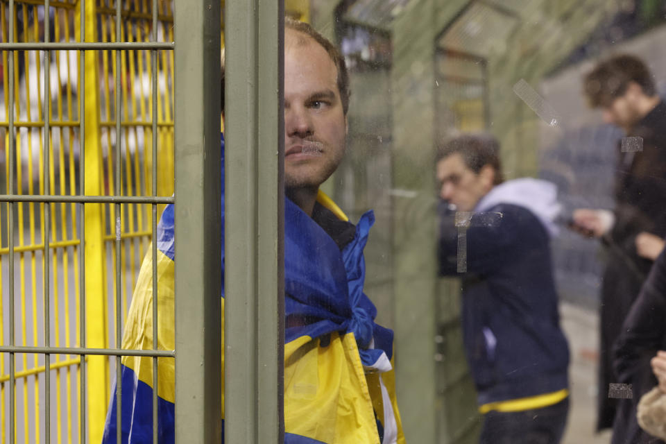 Supporters wait to leave after suspension of the Euro 2024 group F qualifying soccer match between Belgium and Sweden at the King Baudouin Stadium in Brussels, Monday, Oct. 16, 2023. The match was abandoned at halftime after two Swedes were killed in a shooting in central Brussels before kickoff. (AP Photo/Geert Vanden Wijngaert)