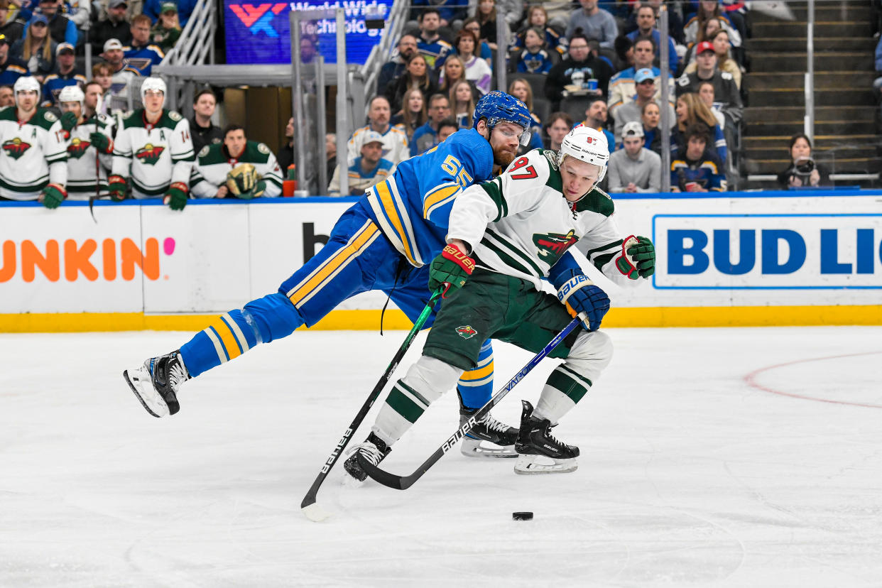 ST. LOUIS, MO - APRIL 16: Minnesota Wild left wing Kirill Kaprizov (97) fights through the poke check attempt of St. Louis Blues defenseman Colton Parayko (55) during a game between the Minnesota Wild and the St. Louis Blues on April 16, 2022, at the Enterprise Center in St. Louis MO (Photo by Rick Ulreich/Icon Sportswire via Getty Images)