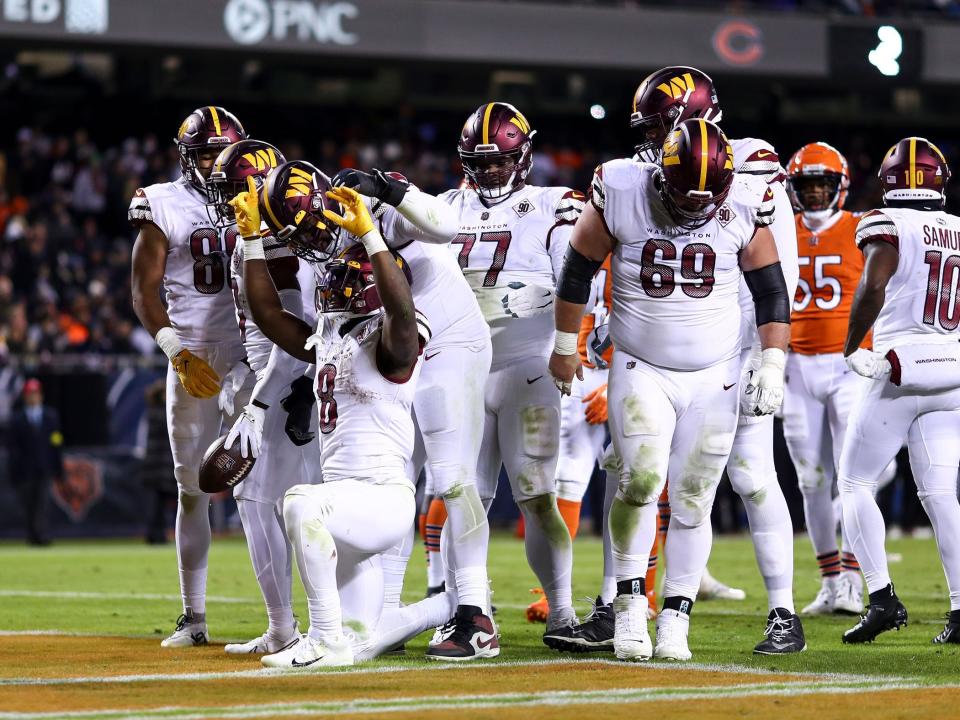 Brian Robinson Jr. celebrates after scoring a touchdown against the Chicago Bears.