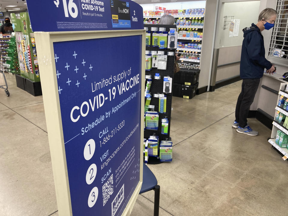 A man checks in for a COVID-19 booster shot at a pharmacy.