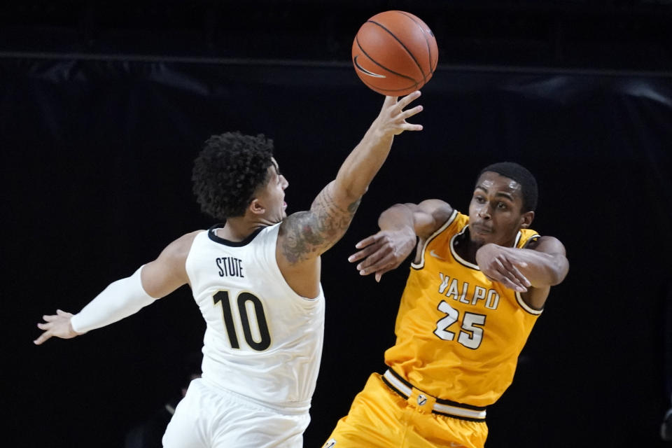 Valparaiso guard Nick Robinson (25) passes the ball past Vanderbilt forward Myles Stute (10) in the first half of an NCAA college basketball game Friday, Nov. 27, 2020, in Nashville, Tenn. (AP Photo/Mark Humphrey)