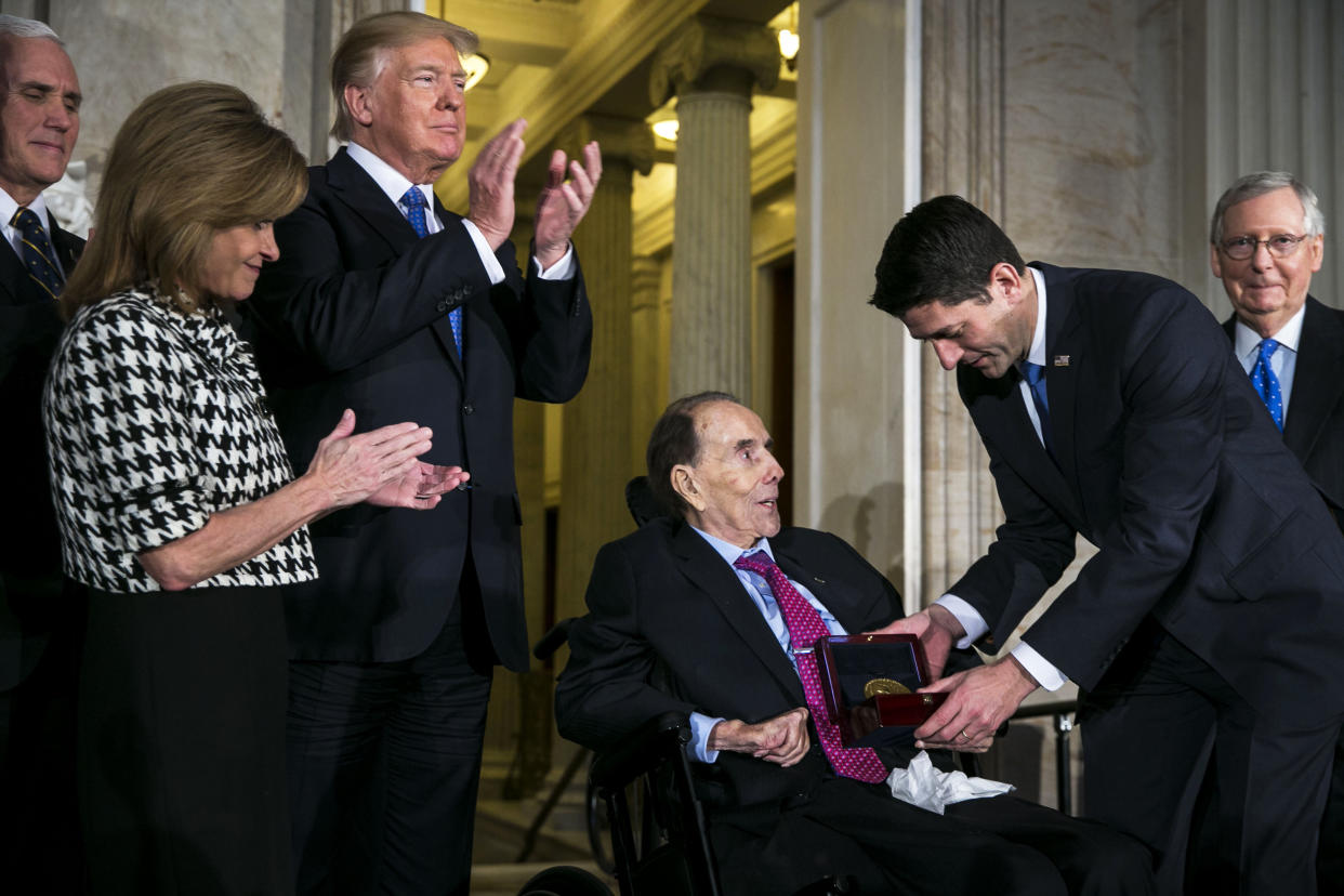 Former Senate Majority Leader Bob Dole, center, is presented with the Congressional Gold Medal by House Speaker Paul Ryan, R-Wis., right, as U.S. President Donald Trump, center left, applauds during a ceremony at the Capitol on Jan. 17, 2018. (Al Drago / Bloomberg via Getty Images file)