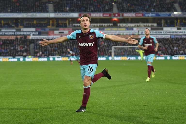 West Ham United's midfielder Mark Noble celebrates scoring the opening goal during the English Premier League football match against Huddersfield Town January 13, 2018