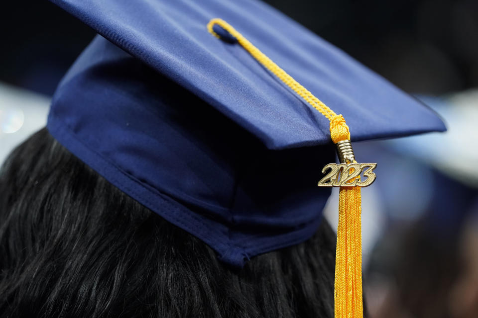 FILE - A tassel with 2023 on it rests on a graduation cap as students walk in a procession for Howard University's commencement in Washington, Saturday, May 13, 2023. The Supreme Court is getting ready to decide some of its biggest cases of the term, including the fate of President Joe Biden’s plan to wipe away or reduce student loans held by millions of Americans. (AP Photo/Alex Brandon, File)