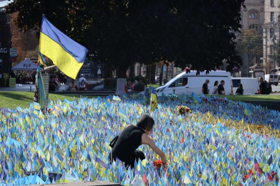 A Ukrainian woman brings flowers to the place of the improvised memorial to the fallen Ukrainian soldiers on Independence Square on Sept. 26, 2023 in Kyiv. (Andriy Zhyhaylo/Obozrevatel/Global Images Ukraine via Getty Images)