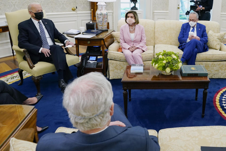 FILE - In this May 12, 2021, file photo President Joe Biden speaks during a meeting with congressional leaders in the Oval Office of the White House in Washington. Clockwise from left, Vice President Kamala Harris, Biden, House Speaker Nancy Pelosi of Calif., and Senate Majority Leader Chuck Schumer of N.Y., and Senate Minority Leader Mitch McConnell of Ky. House Speaker Nancy Pelosi and Senate Majority Leader Chuck Schumer will confer Wednesday, June 23, with White House officials on next steps for President Joe Biden's nearly $4 trillion infrastructure plans as talks with Republicans see-saw in search of a potential deal.(AP Photo/Evan Vucci, File)