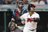 Cleveland Indians' Jose Ramirez, front, and Tampa Bay Rays catcher Mike Zunino watch an RBI triple by Ramirez during the seventh inning of a baseball game, Friday, July 23, 2021, in Cleveland. (AP Photo/Tony Dejak)