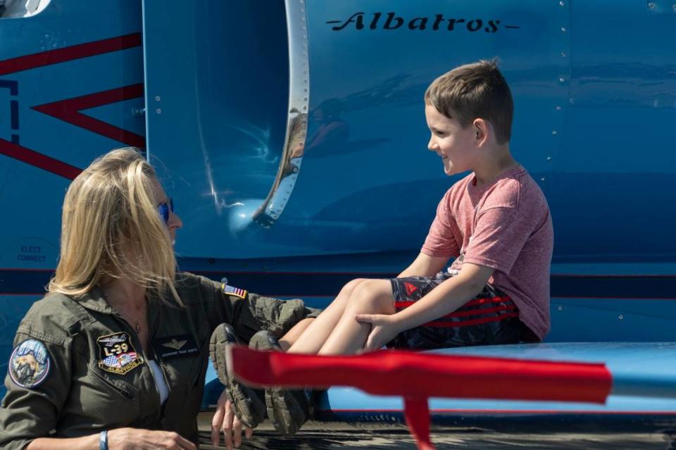 Stephanie “Boss” Goetz talks with a boy as he sits on the wing of her Aero L-39 Albatros at the California Capital Airshow on Sunday at Mather Airport.