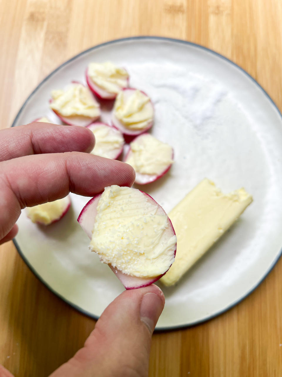 buttered and salted radish in author's hand