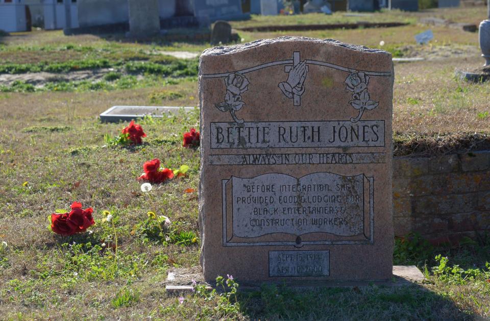 A headstone at Greenwood Cemetery bears the inscription, "Before integration she provided food and and lodging for Black entertainers and construction workers."