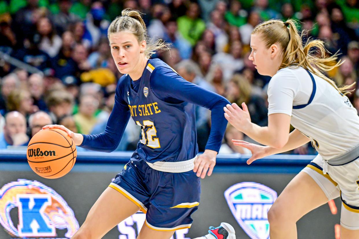 Kent State's Jenna Batsch (12) drives to the basket as Notre Dame's Anna Dewolfe (13) defends in the first half in an NCAA Tournament first-round game Saturday in South Bend, Ind.