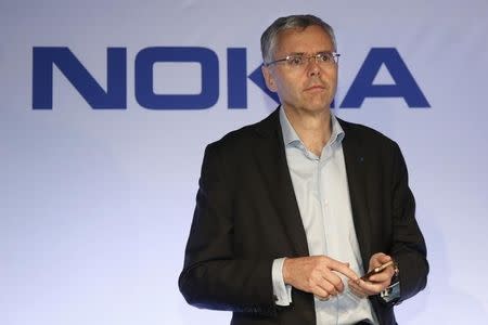 Michel Combes, Telecom equipment maker Alcatel-Lucent Chief Executive Officer, attends a news conference with Nokia in Paris April 15, 2015. REUTERS/Charles Platiau