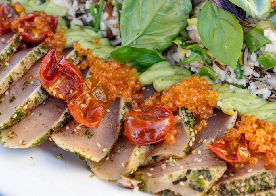 The second course, Furikake-crusted albacore tuna with mixed heirloom rice, is plated at the Tower Bridge Dinner on the Tower Bridge between Sacramento and West Sacramento on Sunday.