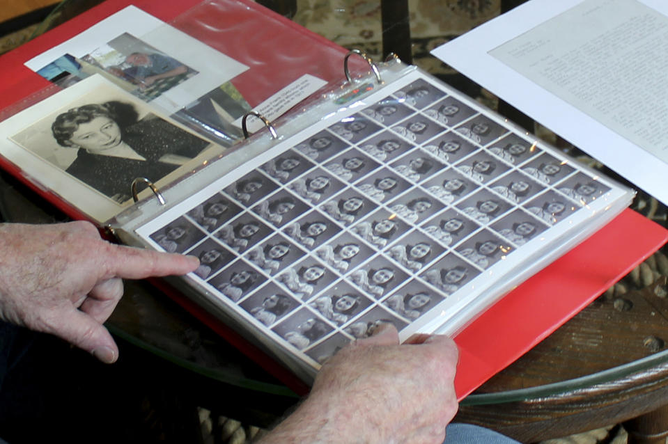 In this June 7, 2019 photo, Ryan Cooper shows photos of Anne Frank that he kept in a scrapbook at his home in Yarmouth, Mass. The 48 small images were made in a photo booth in 1940. Cooper has donated a trove of letters and mementos he received from her father, Otto Frank, to the U.S. Holocaust Memorial Museum ahead of the 90th anniversary of Anne Frank's birthday. (AP Photo/Philip Marcelo)