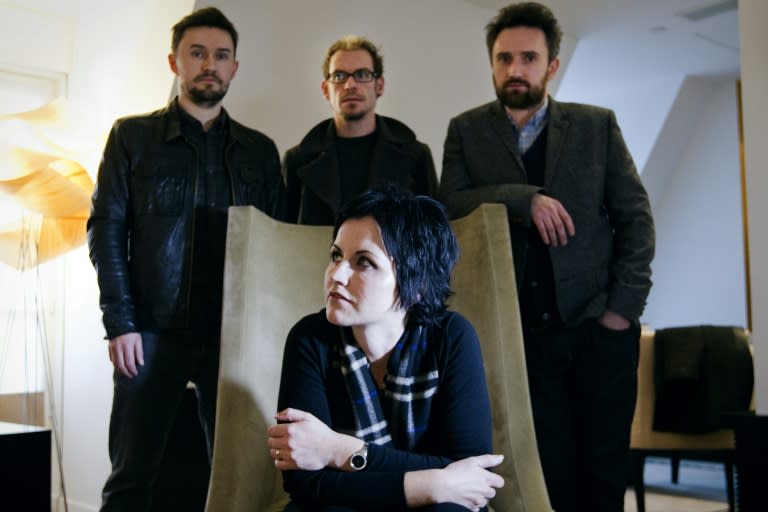 The Cranberries in Paris in 2012. Behind O'Riordan from left to right are bassist Mike Hogan, drummer Fergal Lawler and guitarist Noel Hogan