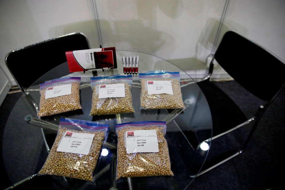 FILE - In this April 12, 2018, file photo, packets of raw soybeans are placed on a table at a U.S. soybean company's booth at the international soybean exhibition in Shanghai, China. China has announced some U.S. industrial chemicals will be exempt from tariff hikes imposed in a trade war with Washington but maintained penalties on soybeans, pork and other farm goods. The Ministry of Finance's announcement Wednesday, Sept. 11, 2019 came ahead of October talks aimed at ending the fight over trade and technology that threatens global economic growth. (AP Photo/Andy Wong, File)