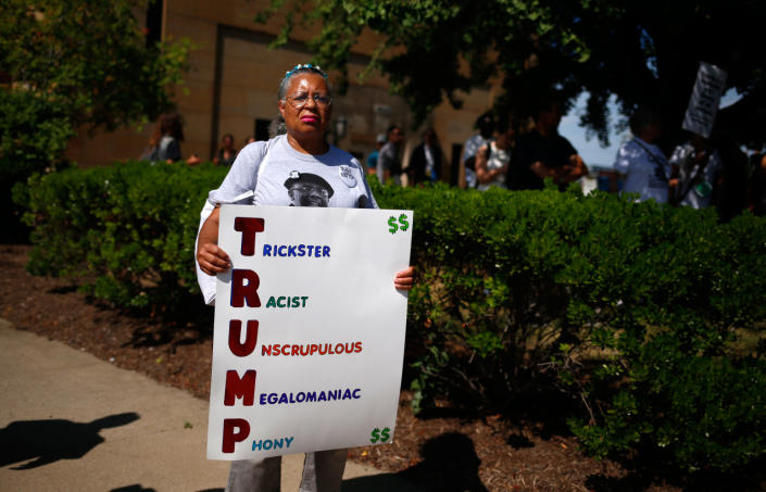 <p>Renla Session holds up a placard during a march ahead of the Republican National Convention in Cleveland, Ohio, on July 17, 2016. (Photo: Shannon Stapleton/Reuters)</p>