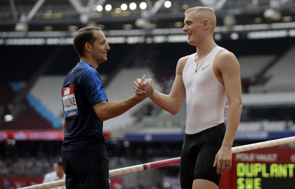 FLE - In this July 21, 2018, file photo, second placed Renaud Lavillenie of France, left, shakes hands with winner Sam Kendricks at the men's pole vault event at the IAAF Diamond League athletics meeting in London. The three biggest names in men’s pole vault will compete against each other from their own backyards, Sunday, May 3, 2020, in a rare sporting event during the coronavirus pandemic. Video links will connect world record holder Mondo Duplantis, world champion Sam Kendricks and former Olympic champion Renaud Lavillenie. World Athletics calls it “The Ultimate Garden Clash” and will stream it on social media. (AP Photo/Matt Dunham, File)