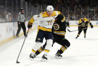 Nashville Predators' Mikael Granlund holds off Boston Bruins defenseman Urho Vaakanainen during the second period of an NHL hockey game Saturday, Jan. 15, 2022, in Boston. (AP Photo/Winslow Townson)