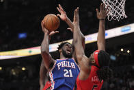 Philadelphia 76ers center Joel Embiid (21) jumps toward the basket as Toronto Raptors forward Precious Achiuwa (5) defends during the second half of an NBA basketball game Thursday, April 7, 2022, in Toronto. (Frank Gunn/The Canadian Press via AP)