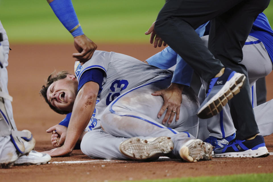 Kansas City Royals relief pitcher Austin Cox winces after an injury during the seventh inning of the team's baseball game against the Toronto Blue Jays on Friday, Sept. 8, 2023, in Toronto. (Nathan Denette/The Canadian Press via AP)