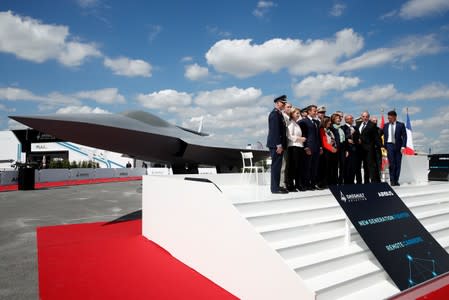 French President Emmanuel Macron, Eric Trappier, Chairman and CEO of Dassault Aviation, Dirk Hoke, CEO of Airbus Defence and Space, attend the unveiling of the New Generation Fighter (NGF) model during a visit the 53rd International Paris A