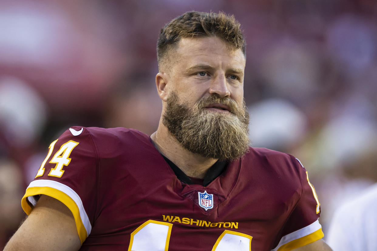 LANDOVER, MD - AUGUST 28: Ryan Fitzpatrick #14 of the Washington Football Team looks on while sitting out the preseason game against the Baltimore Ravens at FedExField on August 28, 2021 in Landover, Maryland. (Photo by Scott Taetsch/Getty Images)