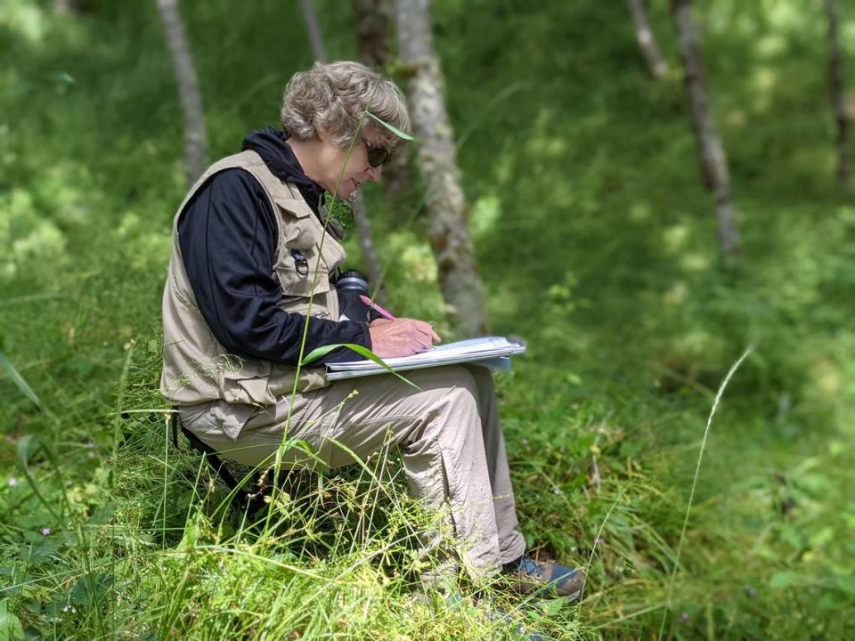 Lead researcher Virginia Dale records the plants observed with percentage of cover on Plot 43 during a July 2022 research expedition to Mount St. Helens.