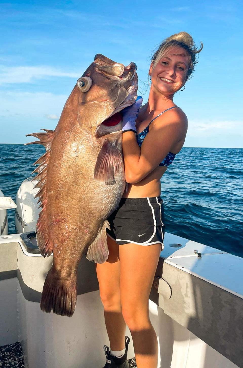 Lori Medlin holds up a massive Snowy Grouper caught while fishing aboard the Chase N Fish vessel overnight out of Steinhatchee.