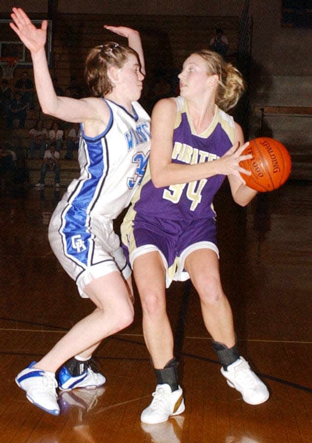 Two future Division 1 girls basketball standouts, Amber Wollschlager of Grant-Deuel (left) and Jennifer Warkenthien of Willow Lake battled against each  other in the 2005 District 3B girls basketball championship in the Watertown Civic Arena. Warkenthien, a senior, led Willow Lake to the title and later starred at South Dakota State. Wollschlager, only a freshman, played her final three years of high school at Milbank and later went on to play at Drake University.