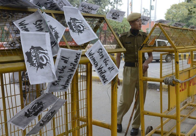 An Indian police officer looks on near a string of anti-rape posters hung over a police barricade at Janatar Mantar in New Delhi on January 28, 2013. Verdicts for five men accused of the fatal gang-rape of a student on a New Delhi bus would be handed down "very soon," a defence lawyer has said, as an application to relocate the trial failed