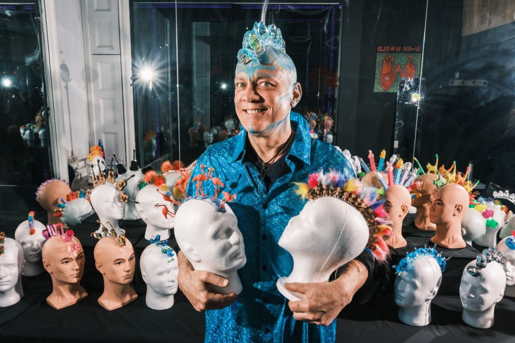 Chris Wink, one of the founders of Blue Man Group, is “making baldness cool” with his large collection of wearable art. Here he models a Stegosaurus-inspired piece. Stephen Yang