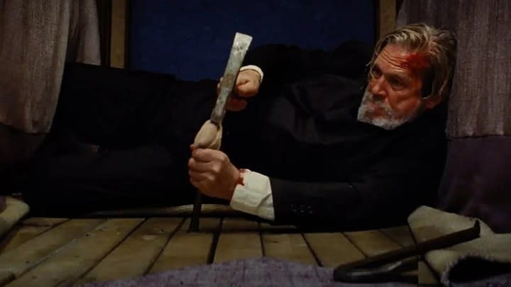 Jeff Bridges lying on the floor with a weapon in a scene from The Old Man on FX and Hulu.