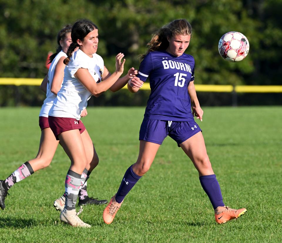 Taylor Simard of Bourne moves the ball ahead of Abbie Golembewski of Case .
