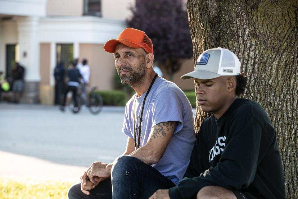 Jorge, 43, and Renny, 22, both from Venezuela, are two of the dozens of asylum seekers that were brought from New York City to the Crossroads Hotel in Newburgh. Both men, photographed outside the hotel May 31, 2023, said that they had to flee their home country because of danger faced by themselves and their families had they stayed. Jorge left a wife and two daughters behind. 