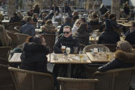 People chat and drink in Medborgarplatsen, Stockholm, Sweden, Saturday, April 4, 2020. Swedish authorities have advised the public to practice social distancing because of the coronavirus pandemic, but still allow a large amount of personal freedom, unlike most other European countries. The new coronavirus causes mild or moderate symptoms for most people, but for some, especially older adults and people with existing health problems, it can cause more severe illness or death. (AP Photo/Andres Kudacki)