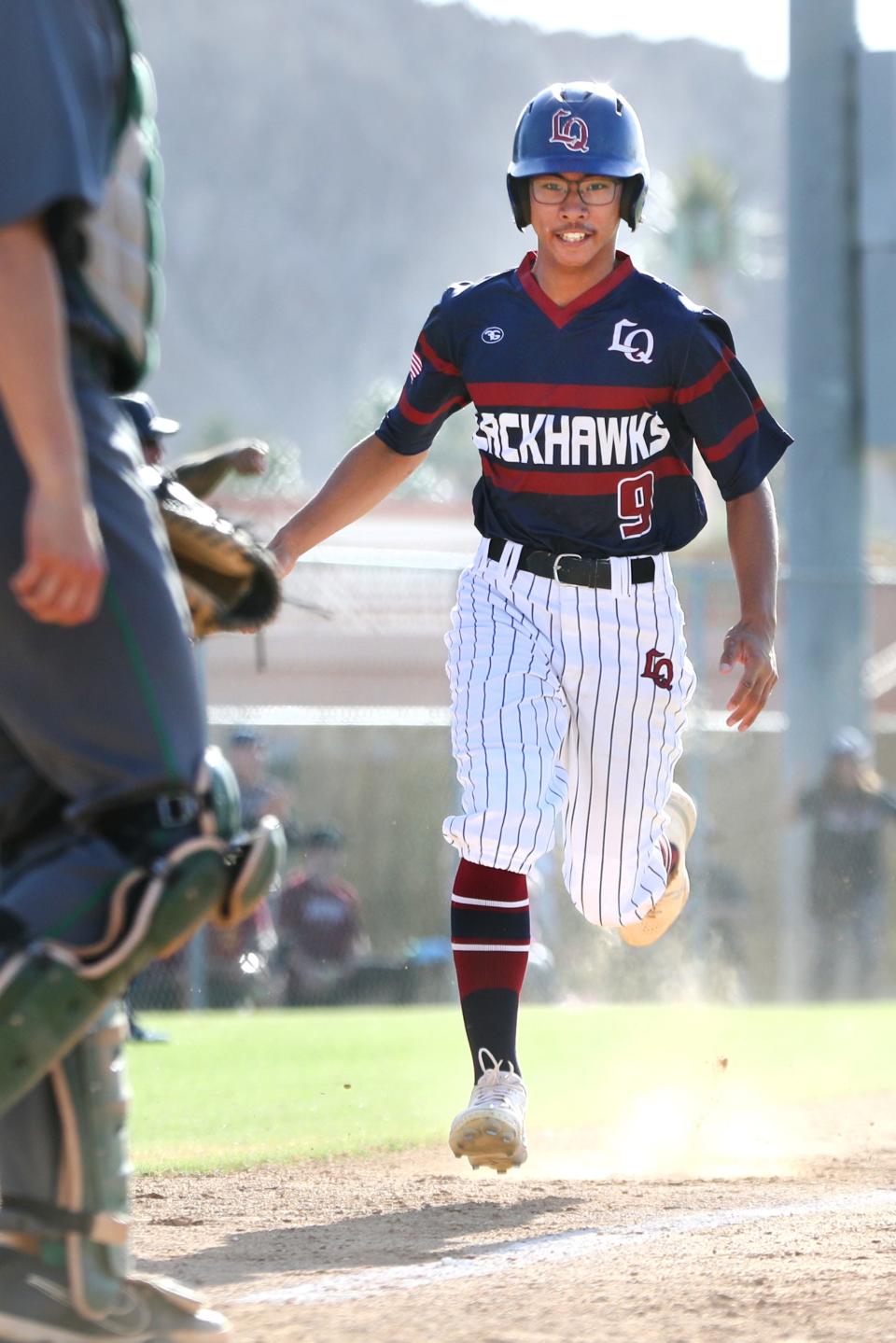 La Quinta High School pinch-runner Alex Rom-Toribio scores the tying run in the seventh inning as the Blackhawks defeated Monrovia 4-3 in their Division 3 CIF-SS playoff game in La Quinta, Calif., on May 10, 2022.