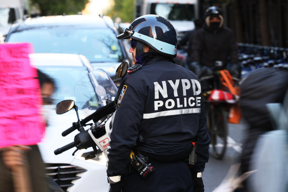 An NYPD officer blocks traffic during a march.