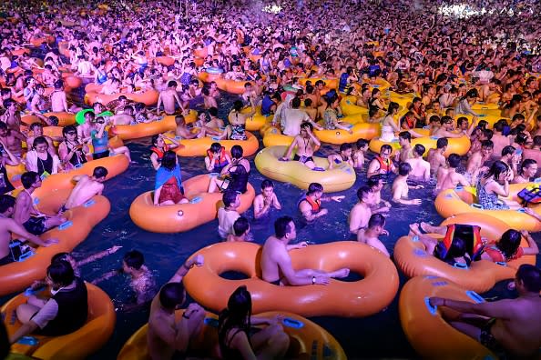 This photo shows people watching a performance as they cool off in a swimming pool in Wuhan in China's central Hubei province. 