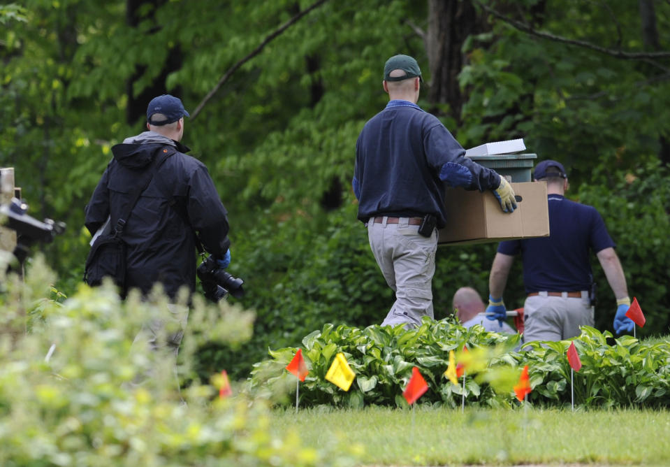 Law enforcement agents search the back yard of reputed Connecticut mobster Robert Gentile in Manchester, Conn., Thursday, May 10, 2012. Gentile's lawyer A. Ryan McGuigan says the FBI warrant allows the use of ground-penetrating radar and believes they are looking for paintings stolen from Boston's Isabella Stewart Gardener Museum worth half a billion dollars. (AP Photo/Jessica Hill)