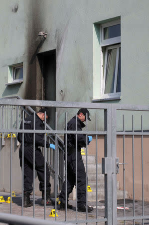 Police inspect the front of a mosque in Dresden, Germany on September 27, 2016, one day after an improvised bomb destroyed the entrance. REUTERS/Matthias Schumann