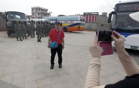 Tourists takes pictures in front of soldiers during the annual Han Kuang military exercise in Kinmen, Taiwan, September 7, 2015. REUTERS/Pichi Chuang