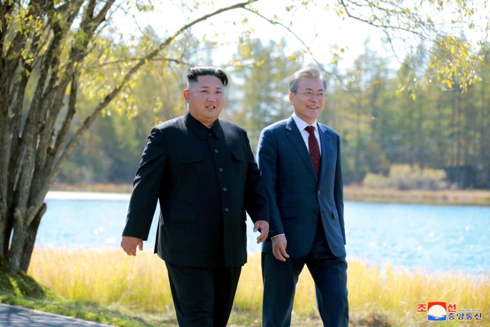 Kim Jong-un (left) and Moon Jae-in walk during a luncheon in 2018 (Reuters)