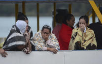 <p>People who survived a sunken ferry, cry as they wait for more information about their missing friends and relatives, at a reservoir in Guatape, Colombia, Sunday, June 25, 2017. (Luis Benavides/AP) </p>