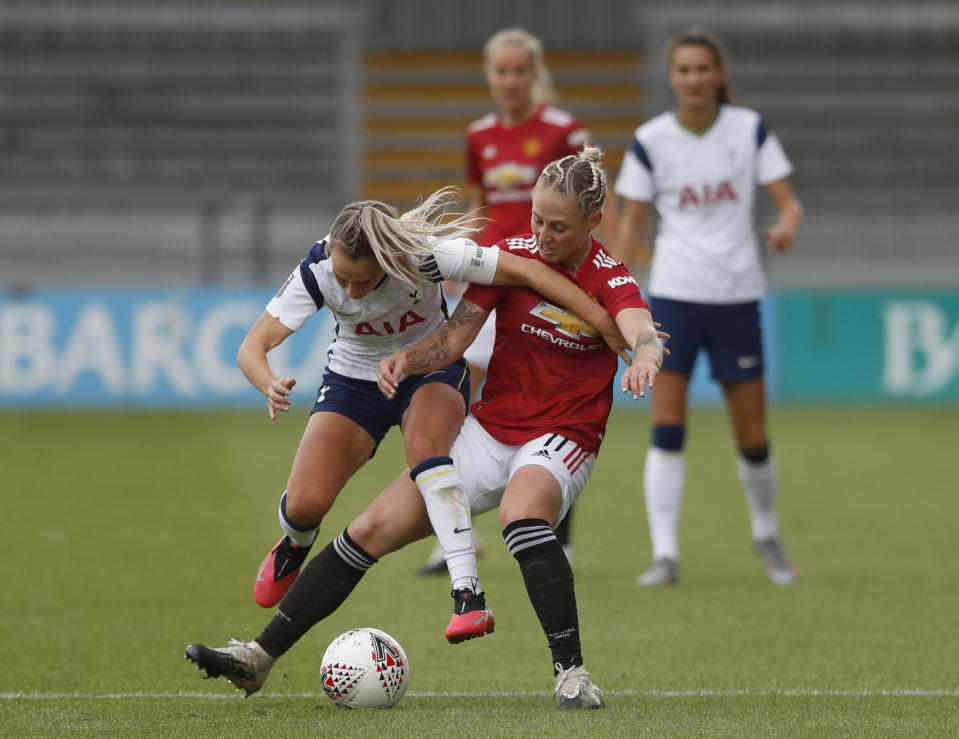 Tottenham Hotspur's Josie Green, left, tackles Manchester United's Leah Galton during the English Women's Super League match between Tottenham Hotspur and Manchester United at the Hive stadium in London Saturday, Oct. 10, 2020. (AP Photo/Alastair Grant)