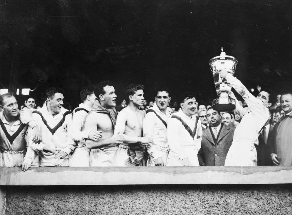 Victorious Great Britain players hold aloft the trophy after winning the inaugural Rugby League World Cup (Bettmann Archive)