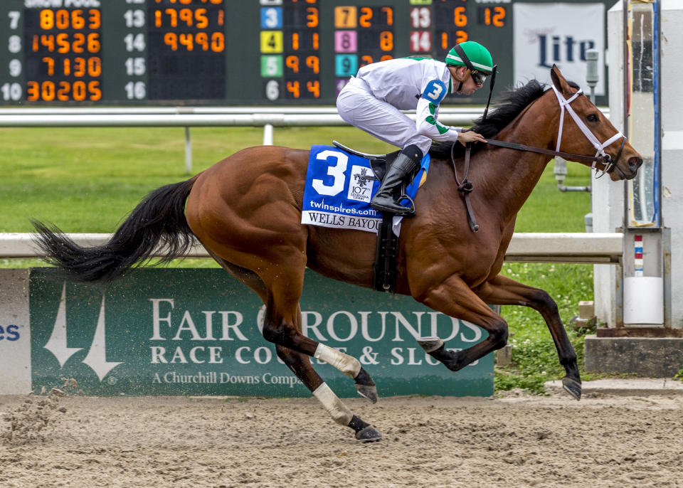 Wells Bayou, ridden by jockey Florent Geroux, wins the 107th running of the $1,000,000 Grade II Louisiana Derby horse race, Saturday, March 21, 2020, at a fanless Fair Grounds race course in New Orleans. (Lou Hodges, Jr./Hodges Photography, Fair Grounds Race Course via AP)