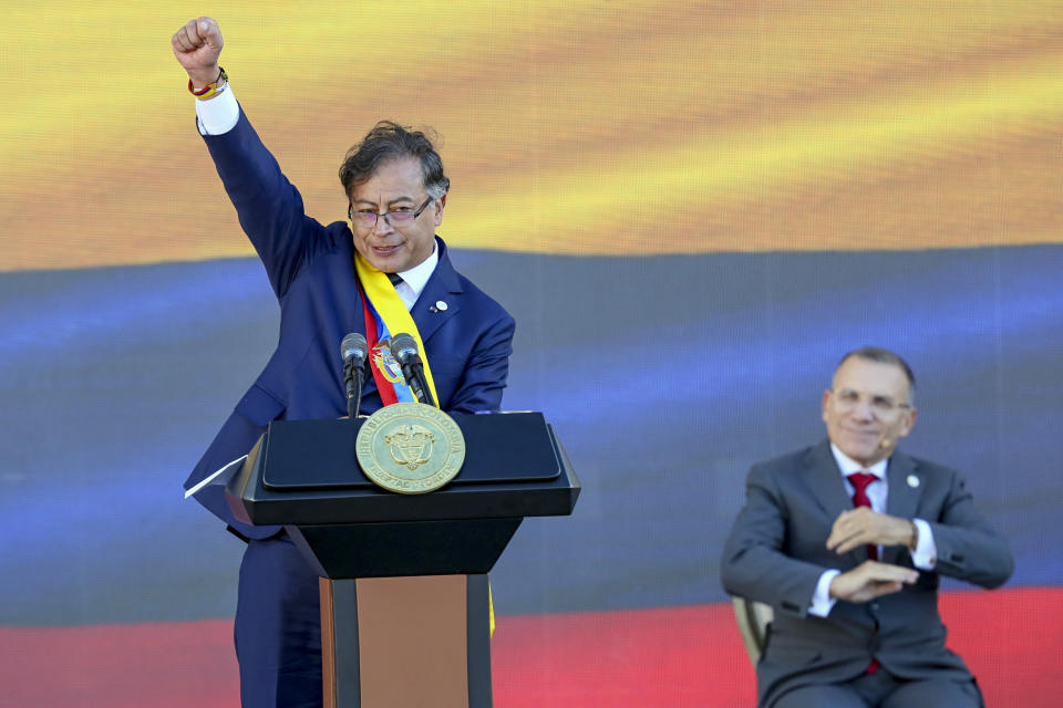 President Gustavo Petro raises his fist at the end of his inauguration speech in Bogota, Colombia, Sunday, Aug. 7, 2022. (AP Photo/Fernando Vergara)
